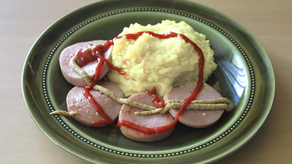 Bangers and mash on a green plate. Photo