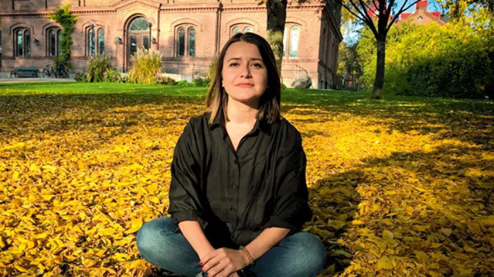 woman in park with autumn leaves