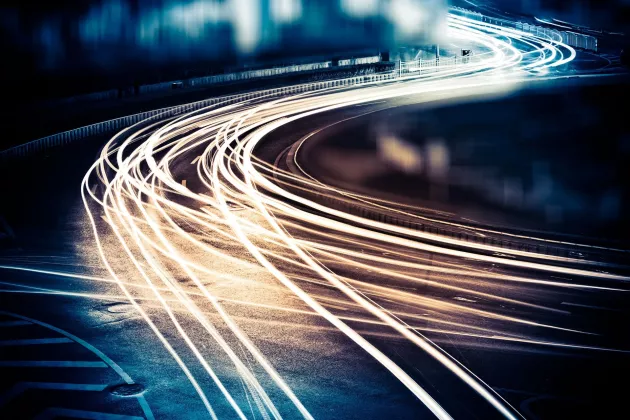 Car lights in the dark on a high way.