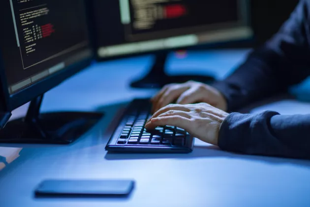Hacker using computer virus for cyber attack. Mostphotos.