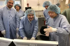 The Prime minister and other in lab clothes in a lab environment.
