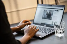 A woman's hands on a laptop's keyboards.