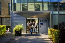 An exterior of an building with some students in front.