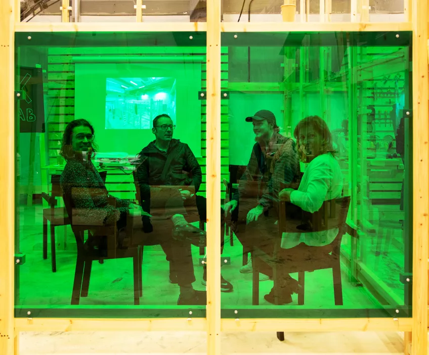 persons sitting a green box having a meeting. Photo: Charlotte Carlberg Bärg