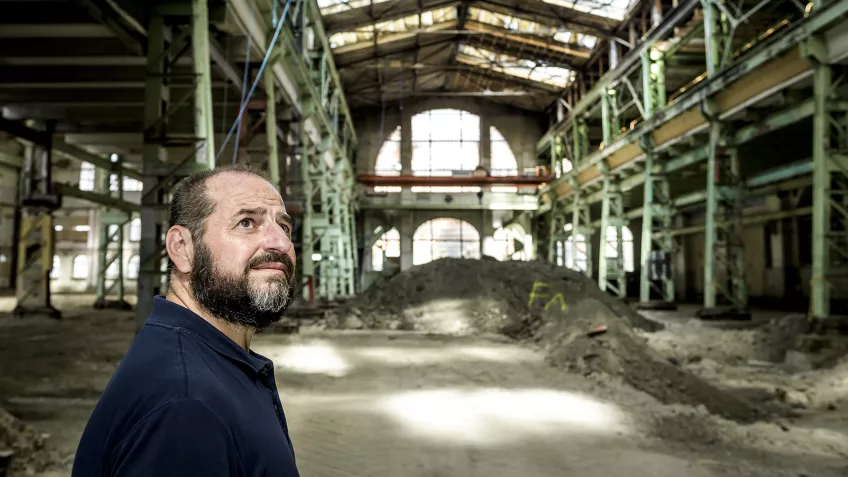 A man inside an old industrial building. Photo