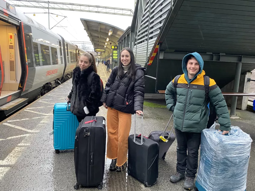 Three students at the train platform.