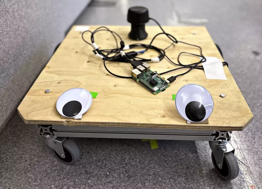 A homemade robot that looks like a skateboard with eyes. Photo