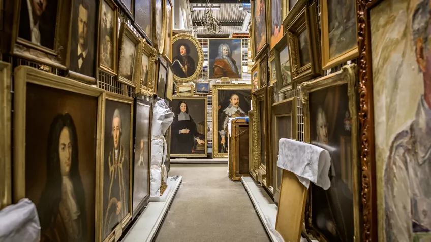 A lot of oil paintings in golden frames