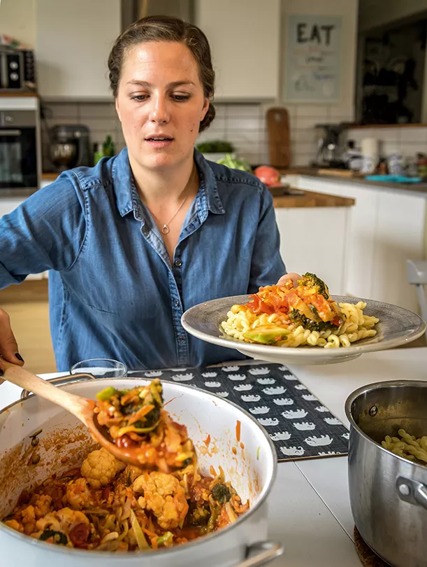 Woman serving food from a casserole
